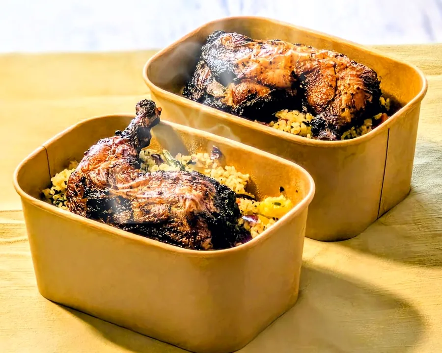 Two bowls of Dambun Rice and grilled chicken, still steaming